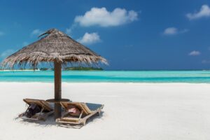palapa and sunbeds on maldives beach